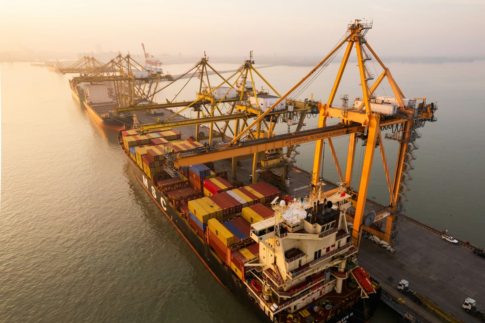 Cargo ship being loaded at a port with large container cranes