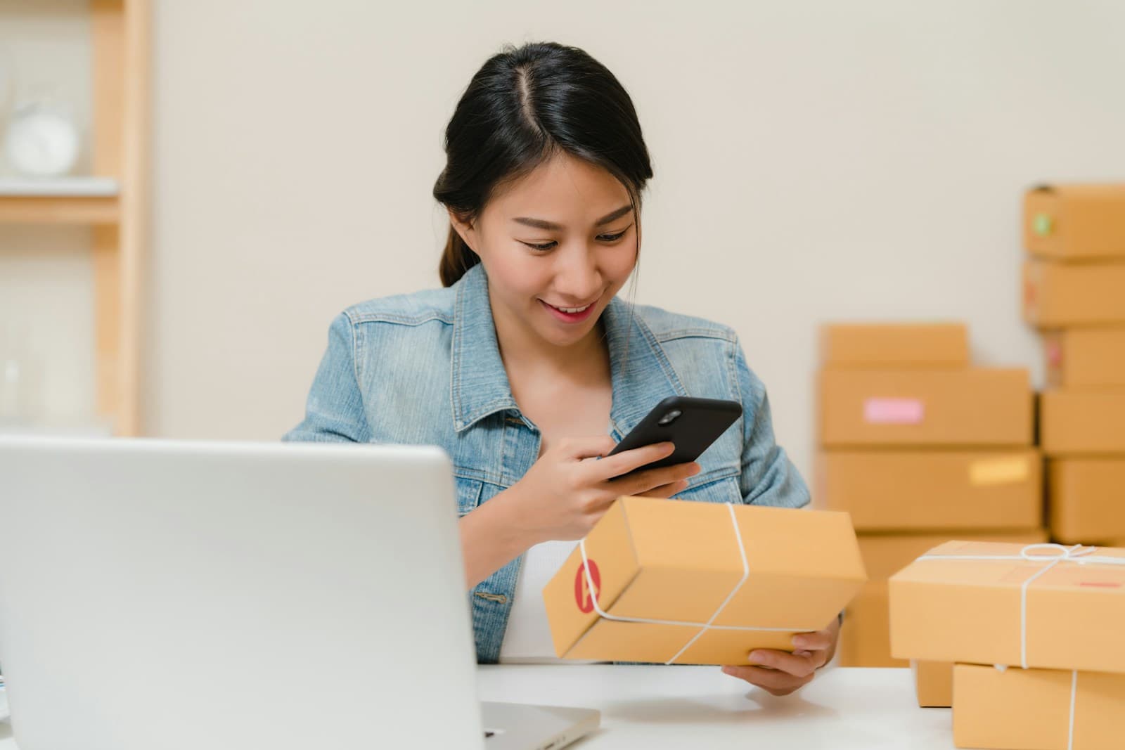 Buyer checking a small supplier sample parcel beside other packages