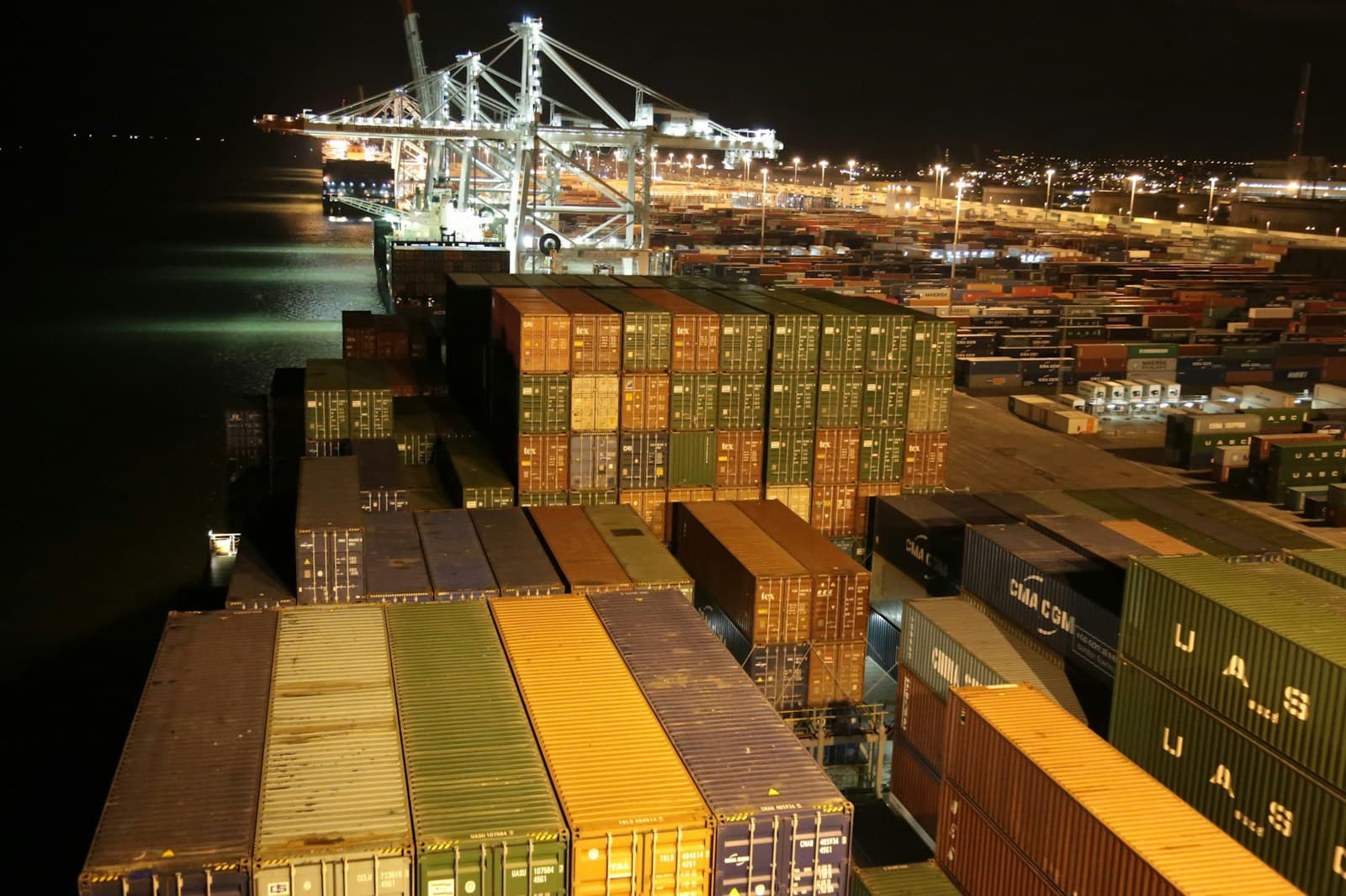 Shipping containers stacked at a busy port terminal