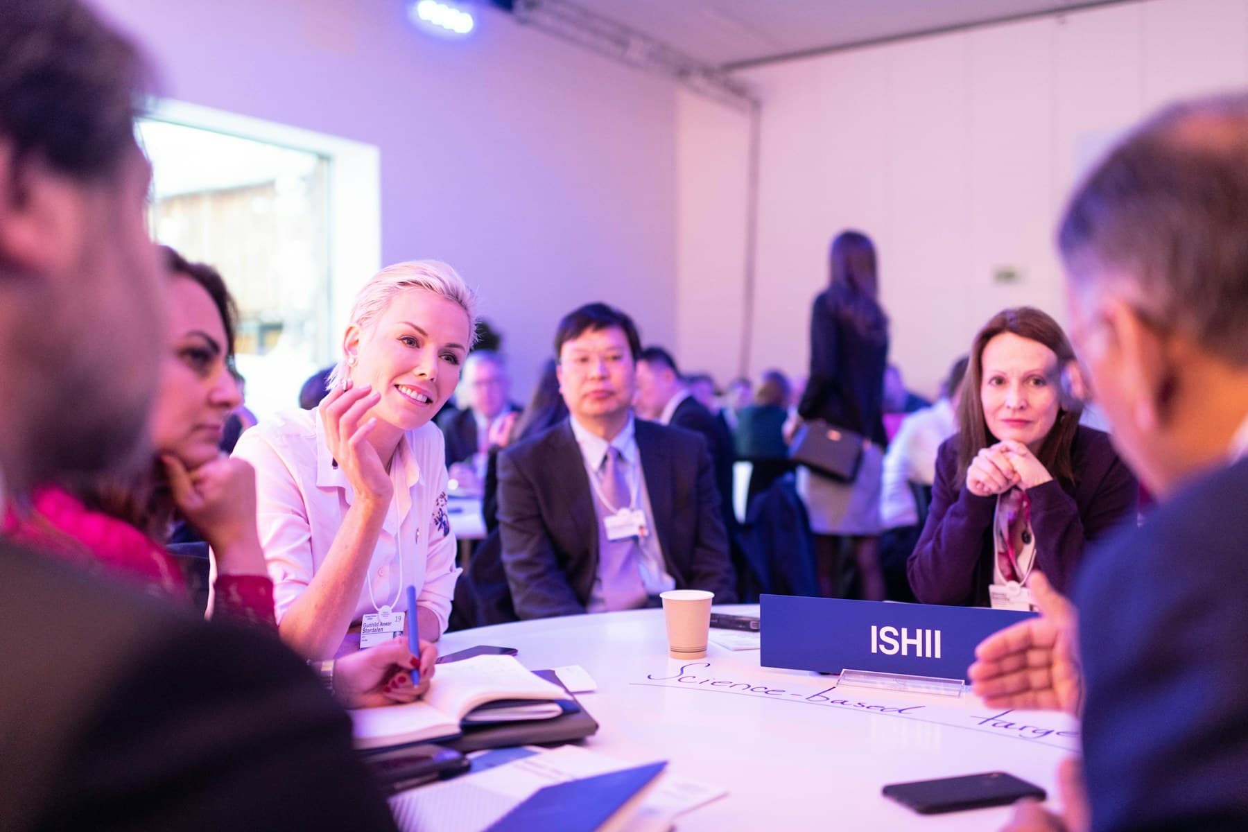 International business participants discussing details around a table